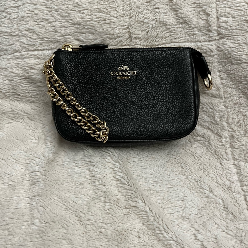 Coach zippered pouch with leather wristlet strap. Good used condition. Black.